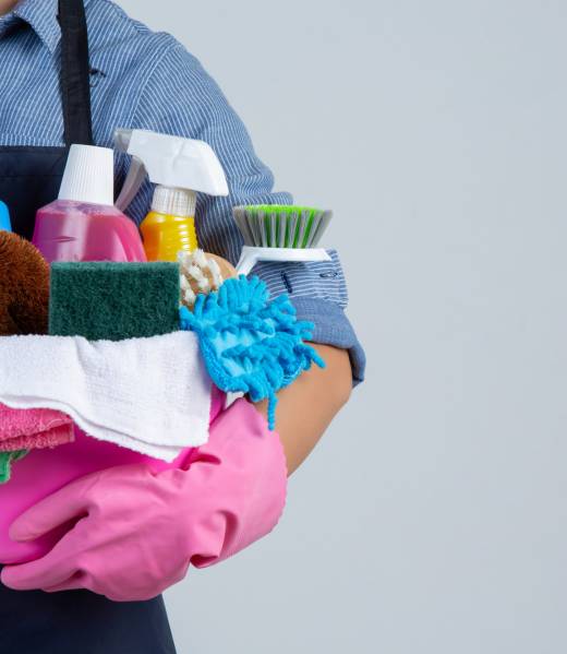 woman-is-holding-cleaning-product-gloves-rags-basin-white-wall